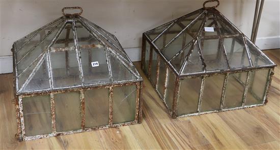 A pair of Victorian iron and class cloches